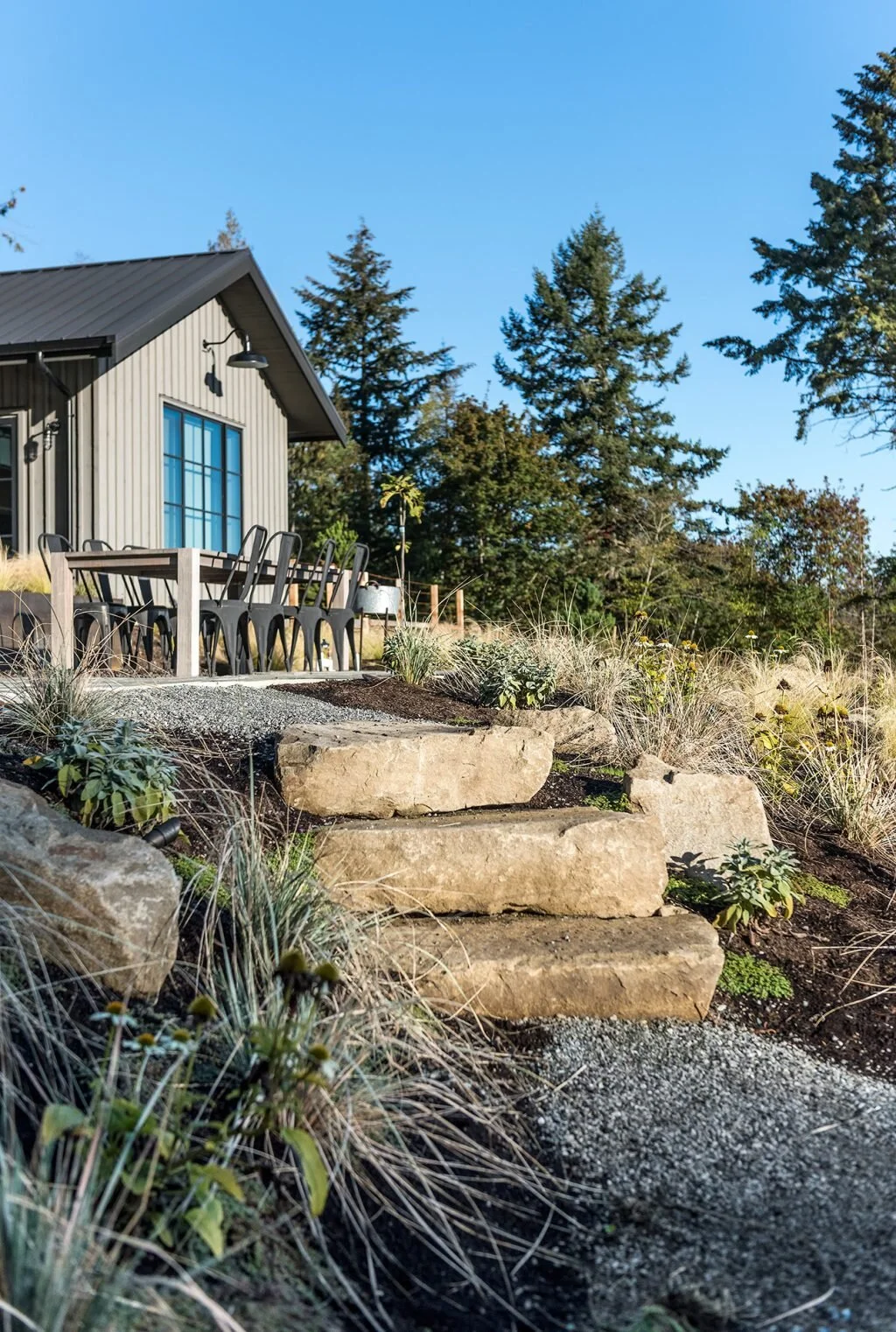 Modern farmhouse landscape on Saltspring Island by Biophilia Design Collective